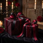 Elegant gothic gift wrap with burgundy damask pattern and black and burgundy ribbon, roses and candles in background.