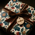 Vintage floral wrapping paper with a brown velvet bow and handmade wooden tag, by Wrapped Studios.