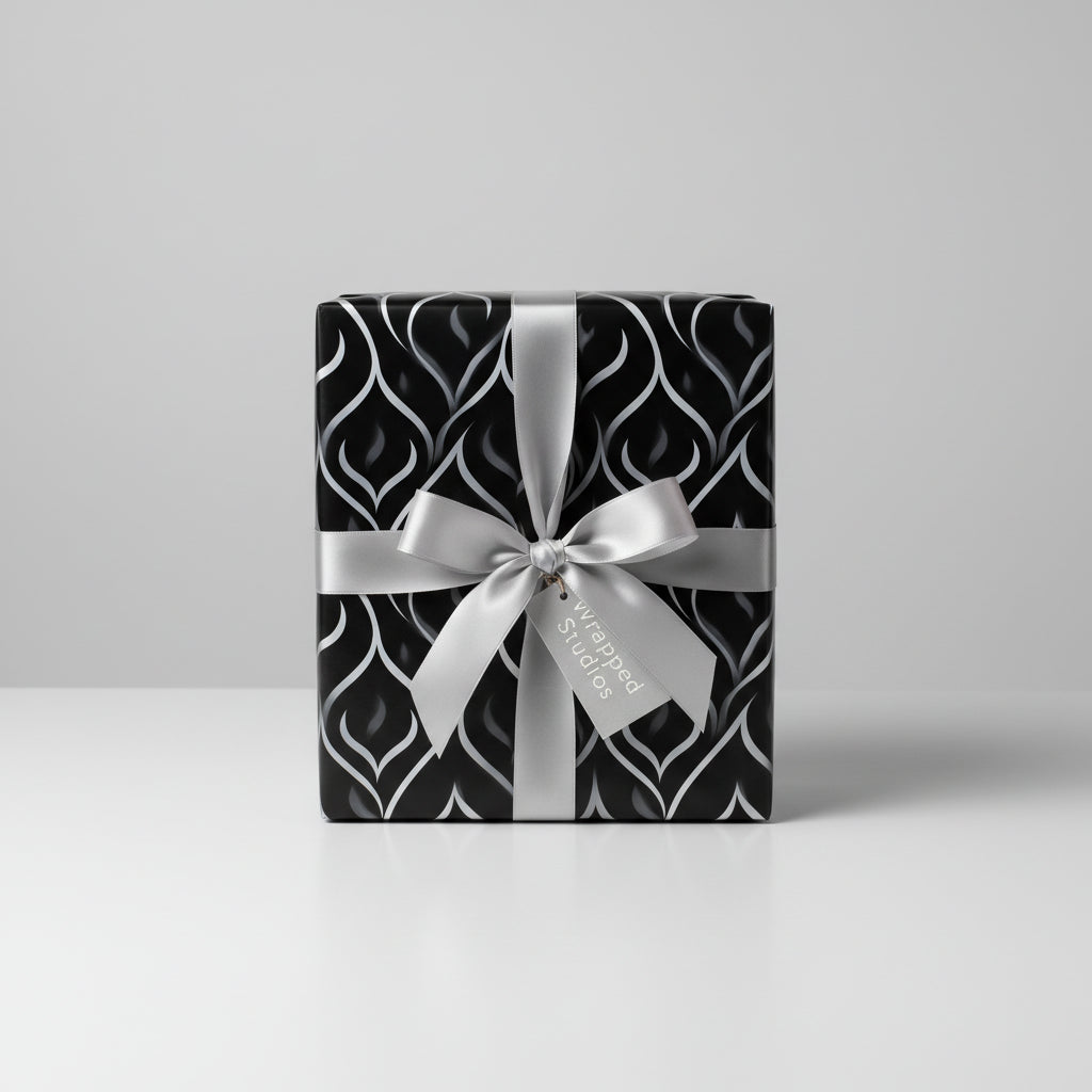 Elegant black wrapping paper with a silver ribbon and modern silver wave pattern.