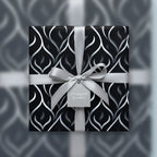 Elegant black and silver luxury gift wrap with ribbon and bow for sophisticated presents.