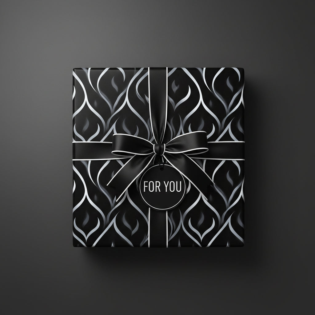 Elegant gift wrapped in black and silver modern wrapping paper with satin ribbon and a "For You" tag.