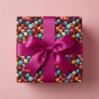 Gift wrapped in colorful macaron pattern paper with a bright pink satin ribbon and bow.