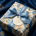 Religious Christmas gift wrap with Virgin Mary pattern and blue satin ribbon by Wrapped Studios.