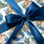 Religious Christmas wrapping paper featuring Virgin Mary and baby Jesus with a blue ribbon by Wrapped Studios.