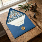 Elegant religious Christmas card in blue envelope with nativity liner and gold wax seal by Wrapped Studios.