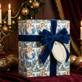 Religious Christmas wrapping paper with Madonna and Child pattern and blue velvet bow by Wrapped Studios.
