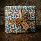 Religious Christmas wrapping paper with Virgin Mary pattern and rustic twine tag. Wrapped Studios.