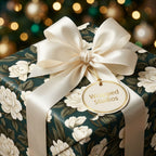Luxury dark green floral wrapping paper with cream satin bow, Christmas gift wrap by Wrapped Studios.