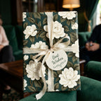 Luxury dark green floral wrapping paper with cream ribbon and Best Wishes tag by Wrapped Studios.