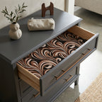 Brown marble wrapping paper used as a luxury drawer liner inside a grey dresser, by Wrapped Studios.