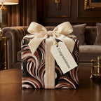 Luxury brown marbled wrapping paper with a cream velvet bow and gift tag, by Wrapped Studios.