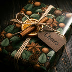 Rustic Christmas gift wrap with botanical pinecone pattern and twine bow by Wrapped Studios.