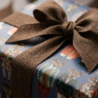 Vintage stag wrapping paper with a rustic brown textured bow by Wrapped Studios.
