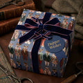 Luxury masculine wrapping paper with dapper stag pattern and navy velvet bow by Wrapped Studios.