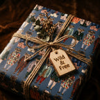Navy blue woodland animal wrapping paper with a rustic twine bow by Wrapped Studios.