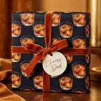"Cheers, Dad" gift wrapped in whiskey-patterned wrapping paper with a velvet ribbon bow.