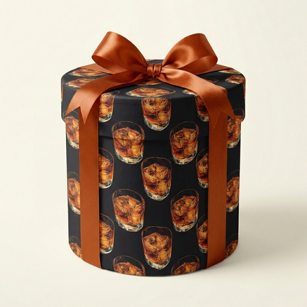 Round gift box in novelty whiskey glass print wrapping paper with copper ribbon.