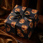 Dark, luxury gift wrap featuring a whiskey glass pattern and a black ribbon with gold trim.