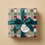 Vintage tile wrapping paper with a teal satin bow, ideal for luxury holiday gifts. By Wrapped Studios.