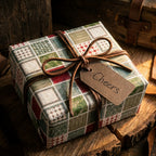 Rustic patchwork wrapping paper on a gift box with a leather bow and Cheers tag by Wrapped Studios.