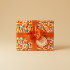 Colorful modern wrapping paper on a square gift box with orange ribbon and "A Special Gift" tag.