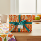 Wrapped gift with retro dot wrapping paper, teal ribbon, and "For You" tag.