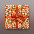 Square gift wrapped in colorful mod wrapping paper with orange ribbon and "Enjoy!" tag.