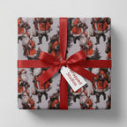 Vintage Santa Claus Christmas wrapping paper with a red satin bow and Wrapped Studios gift tag.