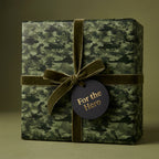 Military camo wrapping paper with helicopter pattern and olive velvet ribbon by Wrapped Studios.