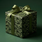 Military helicopter camo wrapping paper with an olive green ribbon on a gift box by Wrapped Studios.