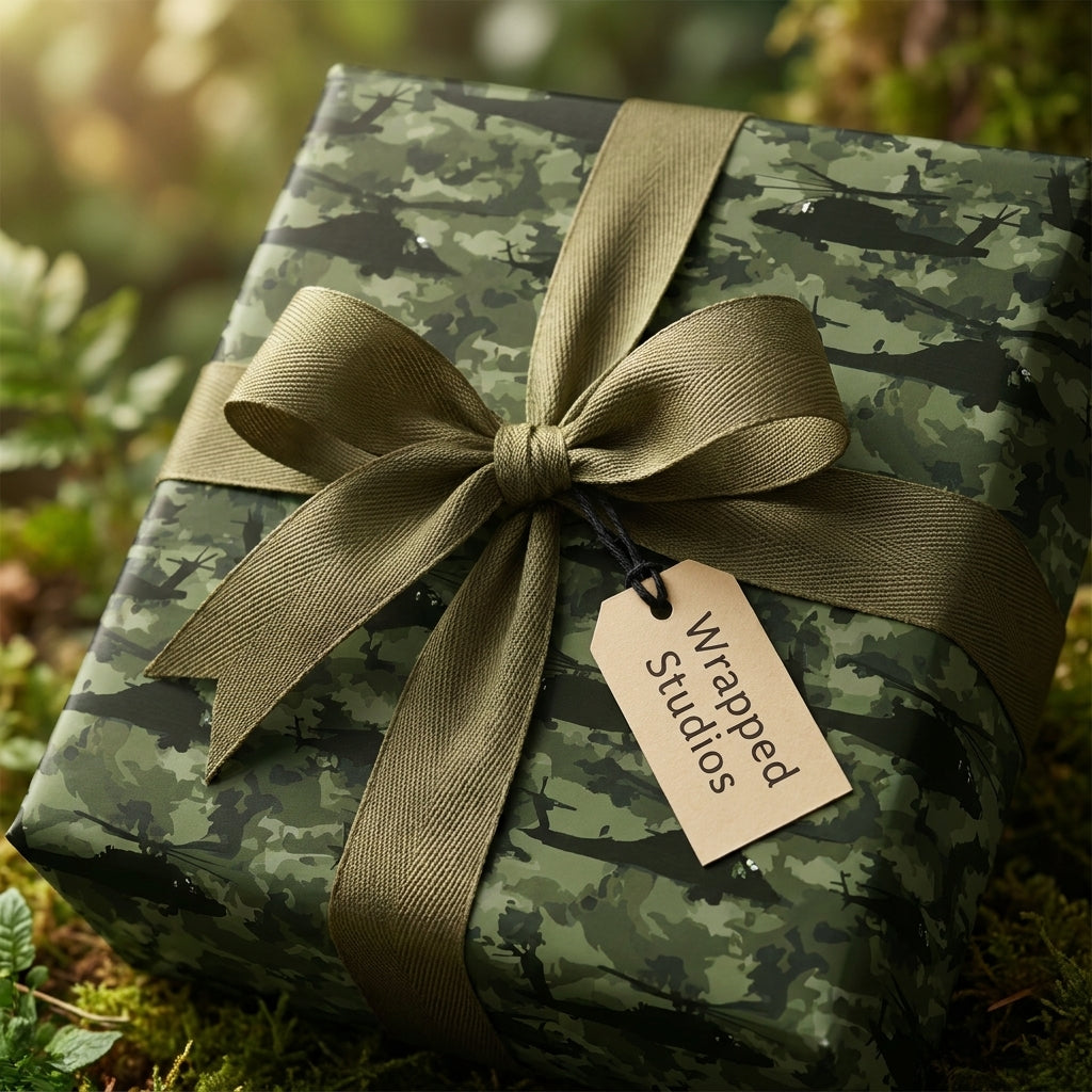 Green camo wrapping paper with helicopter print, olive green bow, and Wrapped Studios gift tag.