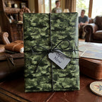 Military helicopter camo wrapping paper with black twine bow on a gift by Wrapped Studios.