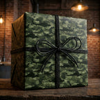 Military helicopter camo wrapping paper with a black twine bow on a gift box by Wrapped Studios.