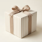 Elegant beige striped wrapping paper with a matching bow on a square gift box by Wrapped Studios.
