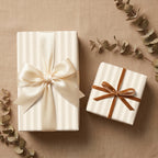 Luxury striped wrapping paper on elegant gift boxes with satin and velvet bows by Wrapped Studios.