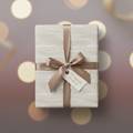 Elegant gift wrapped in cream paper with a delicate pattern and a satin bronze ribbon, perfect for luxury gift wrap occasions.