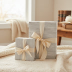 Two presents wrapped in textured gray paper with cream satin ribbon; elegant gift wrap idea.