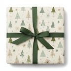 Modern Christmas gift wrap with green, gold, and white trees on a cream background, tied with a dark green ribbon and bow.