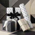 Modern baptism wrapping paper with black crosses on elegant gift boxes by Wrapped Studios.
