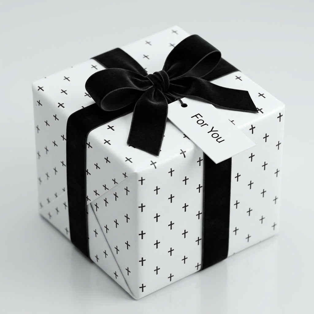 Modern black and white wrapping paper with cross pattern and velvet ribbon by Wrapped Studios.