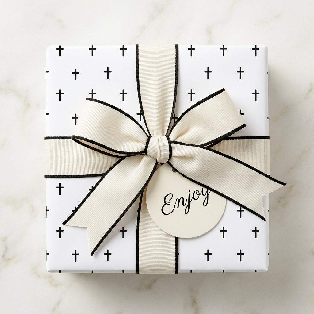 Religious cross wrapping paper with a cream bow on a gift box, perfect for baptism, by Wrapped Studios.