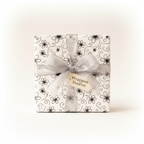 Black and white floral pattern wrapping paper with a sheer silver ribbon and "Wrapped Studios" gift tag, ideal for elegant birthday or wedding gifts.