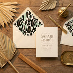 Safari invitation with modern leopard print envelope liner and palm leaves by Wrapped Studios.