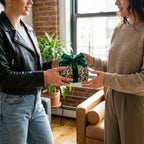Leopard print luxury gift wrap with a green velvet bow on a gift being exchanged, by Wrapped Studios.