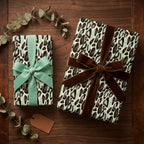 Sage green leopard print wrapping paper with elegant velvet and grosgrain bows by Wrapped Studios.