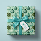 Teal Christmas wrapping paper with vintage ornament pattern and satin ribbon bow by Wrapped Studios.