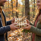 Man exchanging gift with woman, Wrapped Studios beetle print wrapping paper and twine outdoors.