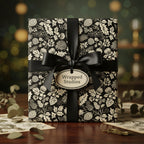 Elegant gift wrapped in black floral wrapping paper with a satin ribbon and bow.