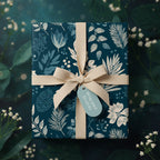 Elegant gift wrapped in navy floral wrapping paper, accented with a cream ribbon and tag.