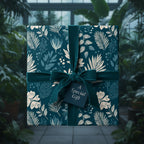 Elegant floral wrapping paper in teal with velvet ribbon, perfect for a special gift.